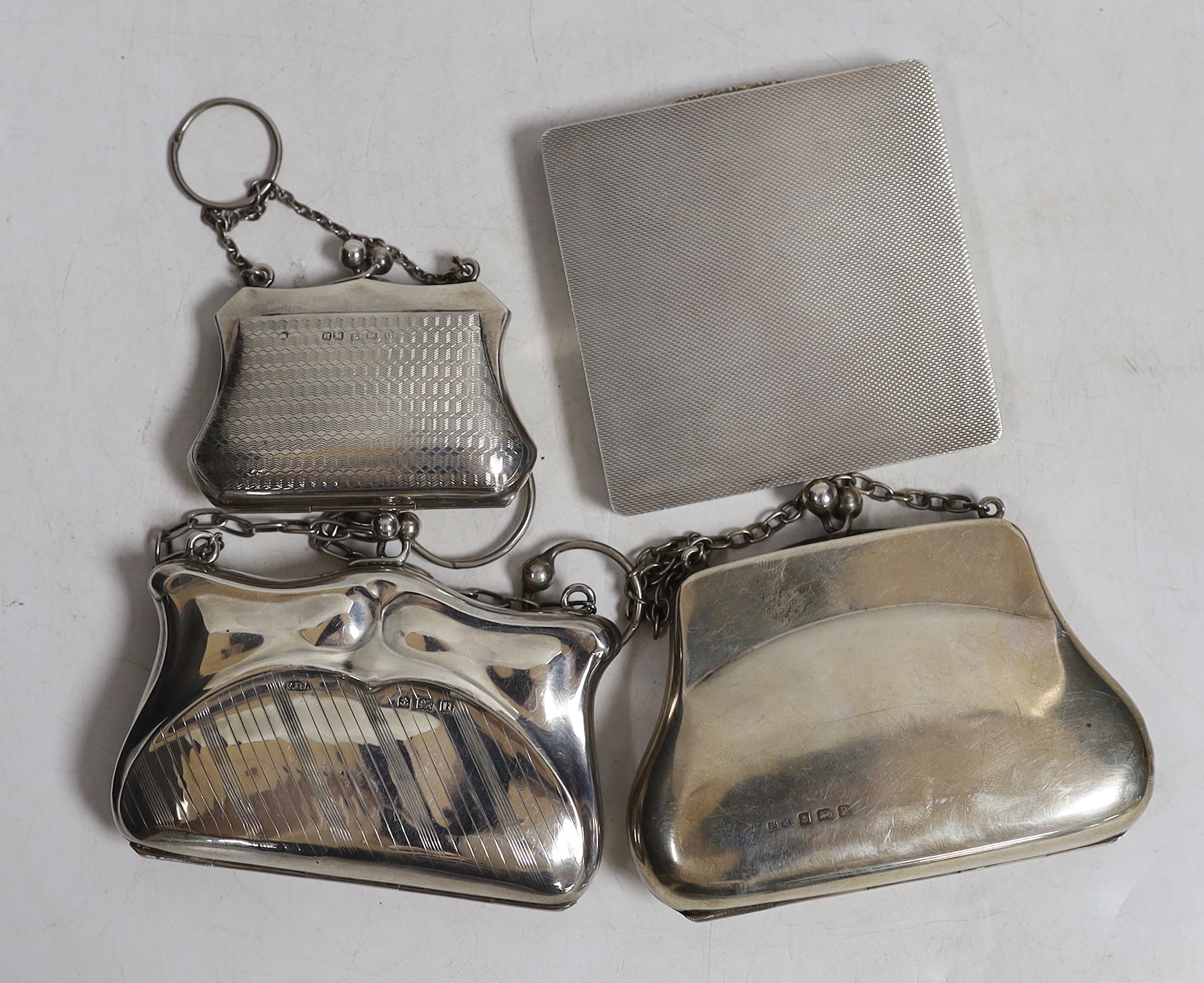 A late Victorian silver handbag purse with suspension chain, Birmingham, 1898, two later silver hand bag purses and a modern engine turned silver compact.